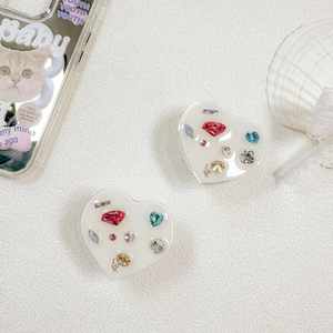 Detailed view of heart-shaped phone grip with colorful rhinestones and Love text