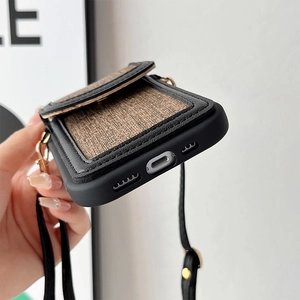 Detailed view of brown fabric wallet phone case with card slot and detachable crossbody strap