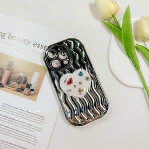 Silver wavy plating phone case with heart rhinestone air sac bracket on a magazine