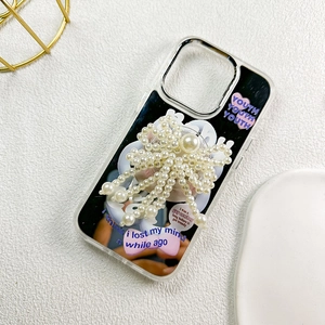 Smartphone case with large pearl bow grip and artistic illustrations on black backplate