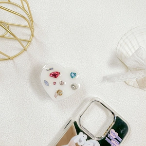 Close-up of heart-shaped phone grip with luxury colorful rhinestones and LOVE text