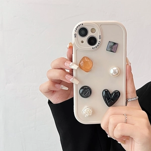 Detail of luxury beige iPhone case featuring vintage style 3D floral and gemstone charms