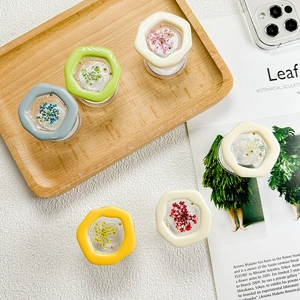 Macro detail of hexagonal resin phone sockets with embedded real dried flowers in multi-colors
