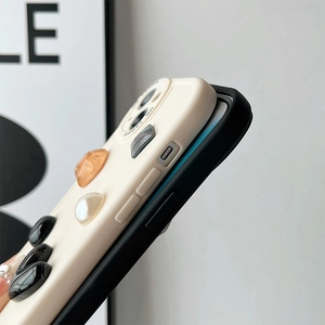 Detail of cream silicone iPhone case with 3D resin gemstones and side button cutouts