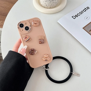 Close-up of beige iPhone case with 3D resin bear and donut charms and silicone wrist strap