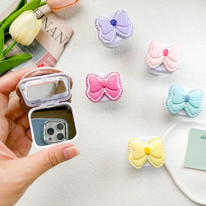 Cute bow collapsible phone grip with compact makeup mirror in pastel purple and pink colors