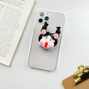 Detail of cartoon girl phone grip with high ponytail and pink flower on silver smartphone