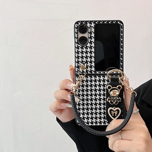 Detail of houndstock foldable phone case with rhinestone bear charm and black handle