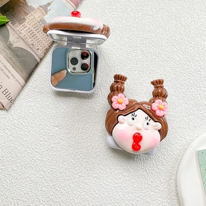 Detail of 3D cartoon girl character on a portable folding makeup mirror with pink flower