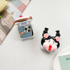 Macro view of portable makeup flip mirror with 3D cartoon girl character phone grip