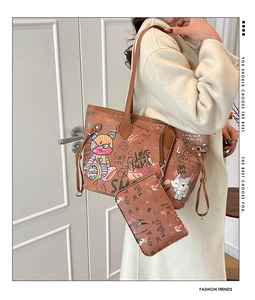 Close-up of graffiti bear bucket tote bag and matching inner pouch with shoulder strap