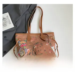 Detail of graffiti pattern camera bag set with wide strap and matching small pouch