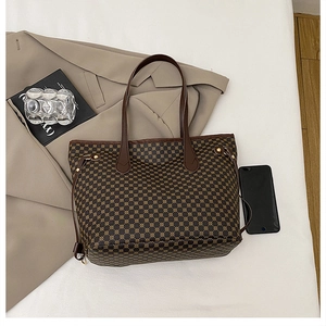 Detailed top view of brown geometric printed tote bag with side drawstring and accessories