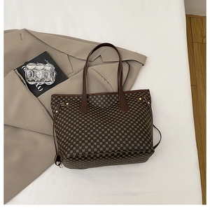 Detail of vintage tote bag with geometric diamond pattern and brown leather straps