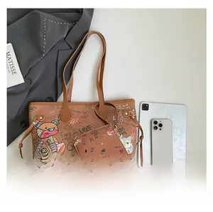 Detail view of graffiti-print tote bag set with vibrant bear and cat art patterns