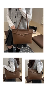 Detail view of large brown pebble leather tote bag with gold buckle and stitching