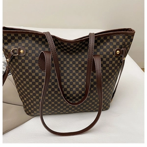 Detail of vintage tote bag with golden geometric patterns and sturdy side metal buckles