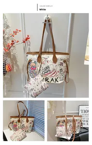 Detail view of a white graffiti tote bag set with brown leather handles and colorful prints