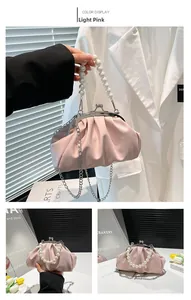 Detail of light pink pleated cloud bag with large pearl handle and silver chain strap