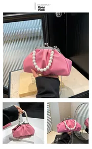 Detail of rose pink cloud bag featuring pearl handle and silver metal clasp closure