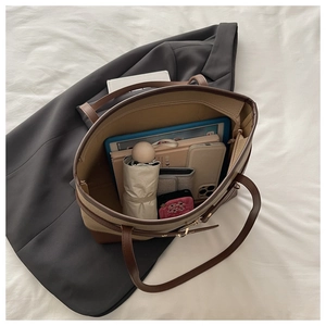 Top view showing spacious interior of a brown leather tote bag with daily essentials