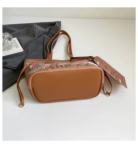 Detail of brown graffiti tote bag set with matching pouch and stylish print patterns