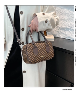 Detail of Boston-style brown monogram handbag with golden JINGPIN logo and strap