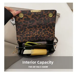 Internal layout of leopard print crossbody bag showing dual compartments and storage capacity
