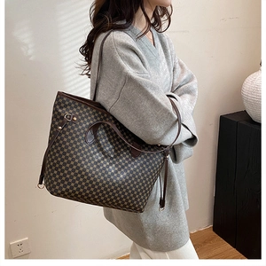 Detailed view of vintage print tote bag with contrasting trim and long shoulder strap