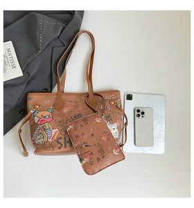 Detail view of brown graffiti tote bag set with cartoon bear print and small pouch