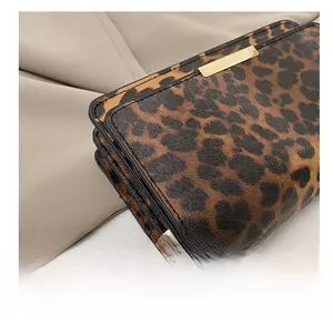 Detail showing high-quality stitching and leopard print texture on the chain bag