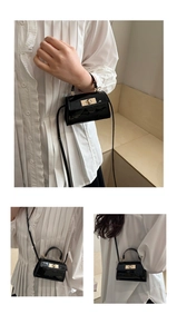 Detail der schwarzen Lackleder-Mini-Tasche mit goldenem Drehverschluss und Glanzeffekt