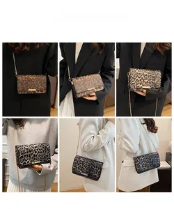 Detail view of leopard print crossbody bag with gold chain strap on a model outfit