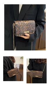 Detail of leopard print handbag featuring gold chain strap and metal trim on flap cover