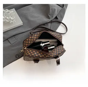 Top view of brown geometric handbag showing spacious interior for tablets and perfumes