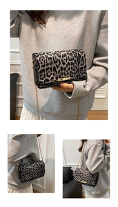 Detail of leopard print handbag with golden chain strap and magnetic flap closure