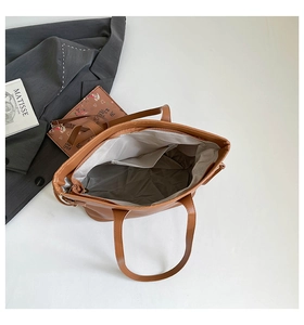 Top view of large brown tote bag showing spacious interior with zipper and inner pocket