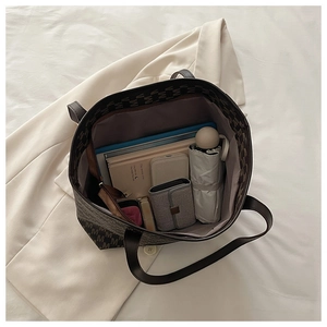 Internal view of large tote bag showing capacity for tablet, umbrella and books