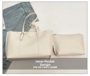 Detail view of large cream tote bag with matching inner pouch and fashion lettering