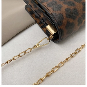 Close-up of leopard print bag with gold chain strap and detailed black edge paint finish