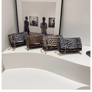 Collection of four leopard print crossbody bags with golden chain straps and metal bars