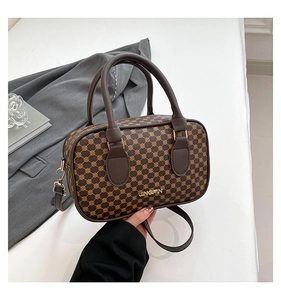 Detailed macro of a brown geometric patterned mini Boston bag with gold JINGPIN logo