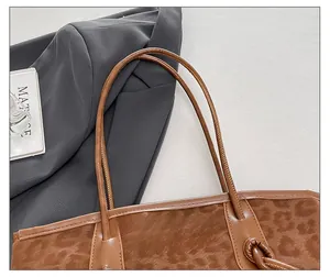 Detail of leopard print tote bag featuring slim leather straps and velvet texture
