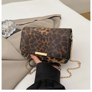 Detail of leopard print shoulder bag with gold metal trim and chain strap