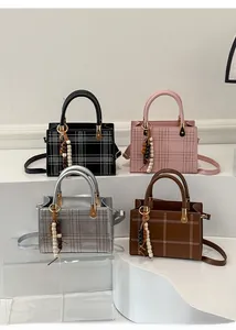 Dettaglio di quattro borse a tracolla vintage a quadri in nero, rosa, argento e marrone