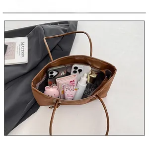Spacious interior of brown PU leather tote bag showing large capacity for daily items