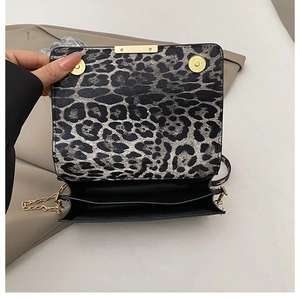 Detail of leopard print crossbody bag with triple internal compartments and gold hardware
