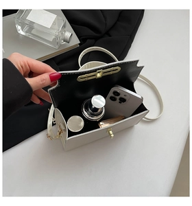 Top view of white structured handbag showing internal space for phone and lipstick