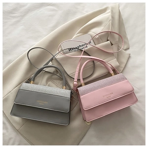 Close-up of glitter flap detail and gold hardware on grey and pink small square bags