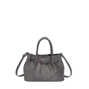 Gray suede bucket bag with leather handles and adjustable shoulder strap on white background